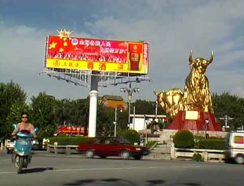 
Traffic circles the gaudy Golden Yaks Monument in Lhasa -  Tibet: Lhasa, Shigatse, Kailash DVD
